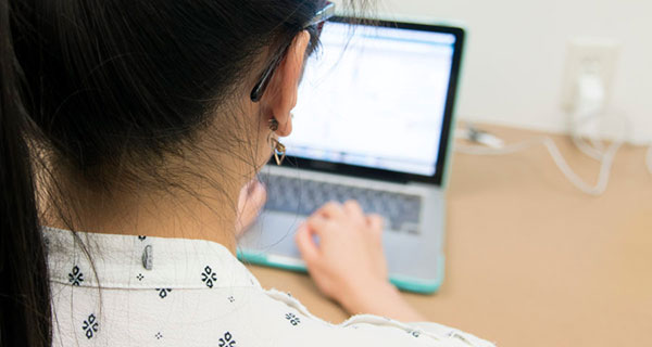 Biotechnology Training Program trainee Edna Chiang working on her computer