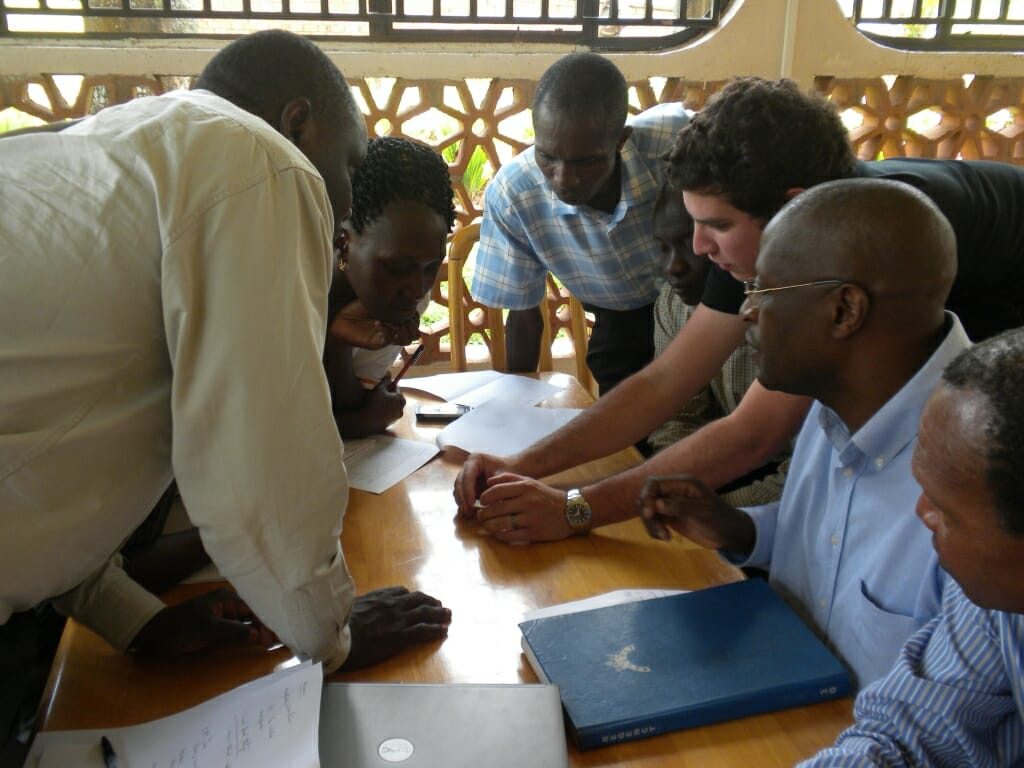 Photo of researchers from Salus Discovery training Uganda-based staff on a diagnostic test for HIV/AIDS