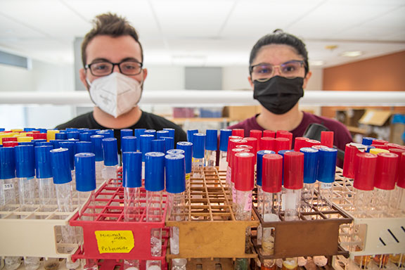 David Rivera_Kohr and Dama Rodriguez-Ramos look over their research in the lab. Photo by Robin Davies.