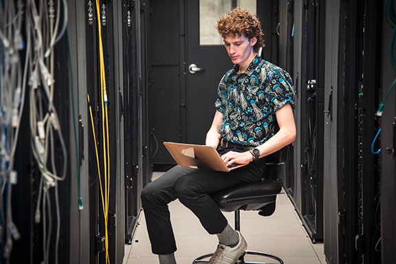 Grant Nickles works in High Throughput Computing Center. Photo by Robin Davies.